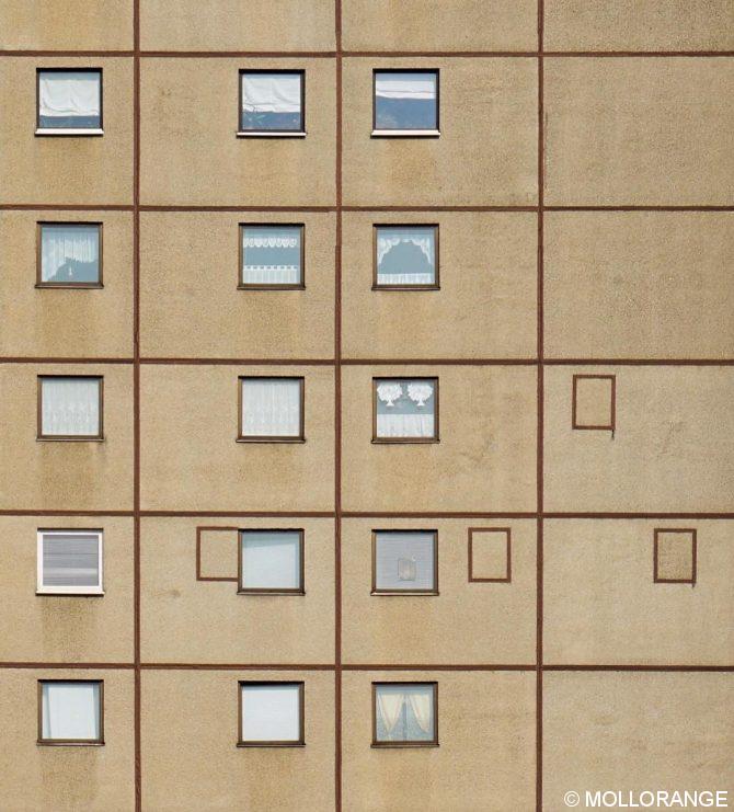 we have three of these buildings in the Ernst-Thälmann-Park in Prenzlauer Berg. Each of them has these little squares - probably as decorative elements? I was always wondering about the strange positioning of the very left one... Somehow funny, somehow wrong... :)